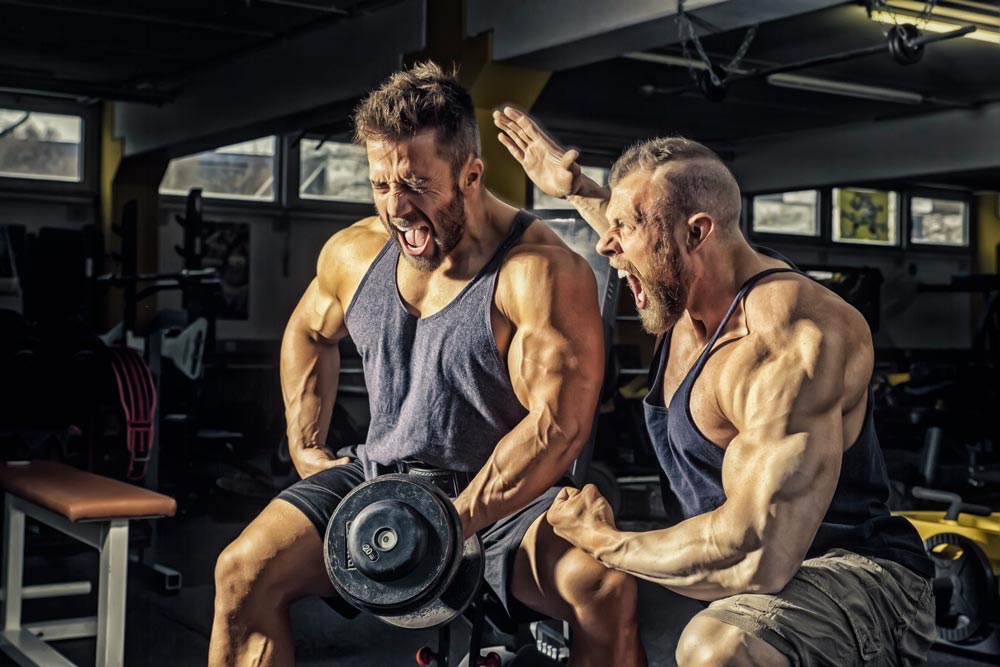 two muscular men working out