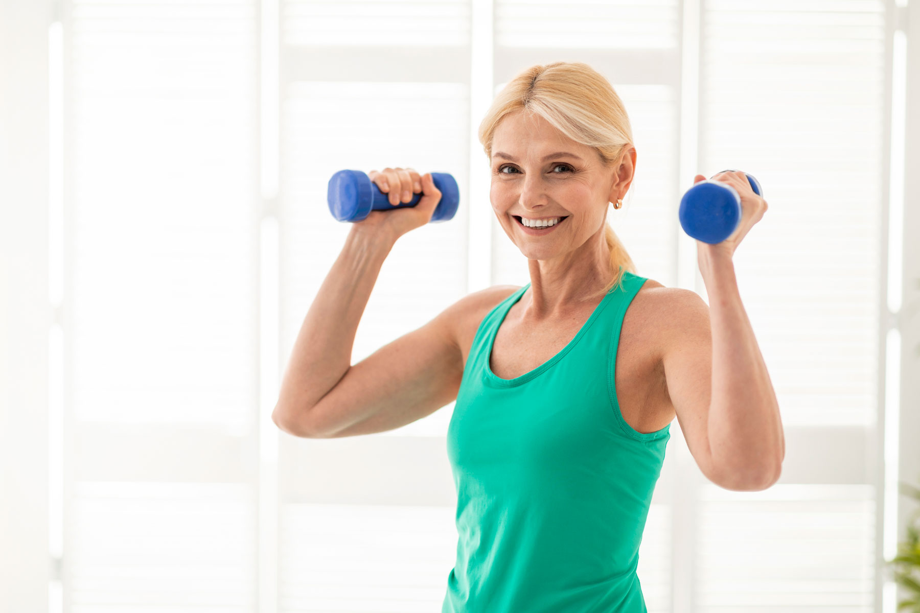 Woman working out with dumbbells.